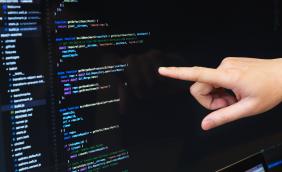 Hand pointing to coding on screen.jpg